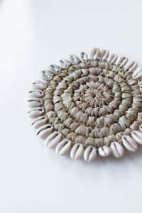Raffia coaster with cowrie shells