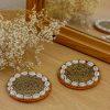 Beaded coaster with cowrie shells